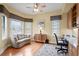 Bright home office with built-in cabinets, natural light, and a comfortable seating area at 19830 Strathmore Pl, Land O Lakes, FL 34638