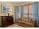 Cozy sitting area with hardwood floors, dresser, and plush seating at 19830 Strathmore Pl, Land O Lakes, FL 34638