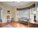 Cozy sitting area with bay windows, hardwood floors, and a comfortable loveseat at 19830 Strathmore Pl, Land O Lakes, FL 34638