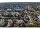 Overhead shot of a home with a lake, street, and abundant trees in a serene residential neighborhood at 1990 59Th N St, St Petersburg, FL 33710