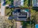 Beautiful aerial view of home featuring a pool, solar panels, and well-maintained landscaping at 1990 59Th N St, St Petersburg, FL 33710
