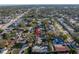 Aerial view of the property showing its location in a residential neighborhood surrounded by mature trees at 1990 59Th N St, St Petersburg, FL 33710