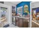 Bar area with sink, wine fridge, granite counters, and exterior access to patio at 1990 59Th N St, St Petersburg, FL 33710
