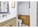 Elegant half bathroom featuring stone accent wall, modern toilet, and vanity with quartz countertop and chrome faucet at 1990 59Th N St, St Petersburg, FL 33710