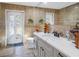 Bathroom with tan tile, a white sink, toilet, and a door to the outside at 1990 59Th N St, St Petersburg, FL 33710