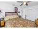 Bedroom with a wooden headboard, nightstands, a ceiling fan, and a closet with white doors at 1990 59Th N St, St Petersburg, FL 33710