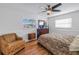 Bedroom with a printed duvet, a wooden headboard, nightstands, and a ceiling fan at 1990 59Th N St, St Petersburg, FL 33710