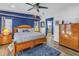 Comfortable bedroom with accent wall, dresser, wood flooring, and doorway to the bathroom provides a relaxing retreat at 1990 59Th N St, St Petersburg, FL 33710