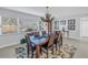 Bright dining area with large windows, a wooden table set, and an eye-catching antler chandelier overhead at 1990 59Th N St, St Petersburg, FL 33710