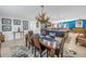 Charming dining area with a wooden table set on a patterned rug, situated adjacent to the kitchen island at 1990 59Th N St, St Petersburg, FL 33710