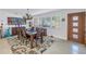 Dining room featuring large window for natural light and wooden table set, adjacent to an art display at 1990 59Th N St, St Petersburg, FL 33710