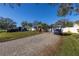 Well-maintained home exterior with beautiful landscaping and paved driveway offering curb appeal at 1990 59Th N St, St Petersburg, FL 33710