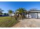 Charming home with well-maintained front yard, lush landscaping, and a paved walkway at 1990 59Th N St, St Petersburg, FL 33710