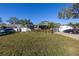 Well-maintained front yard with lush green grass and mature landscaping, creating inviting curb appeal at 1990 59Th N St, St Petersburg, FL 33710