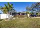 Attractive home with well-manicured lawn, mature trees, and a neatly landscaped front yard at 1990 59Th N St, St Petersburg, FL 33710