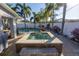 Landscaped backyard with a hot tub, patio, and tropical plants perfect for relaxation at 1990 59Th N St, St Petersburg, FL 33710