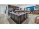 Spacious kitchen island with granite countertop, seamlessly connected to adjacent living spaces for easy entertaining at 1990 59Th N St, St Petersburg, FL 33710