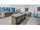 Expansive kitchen island with stylish countertop, seamlessly connected to adjacent living spaces for easy gatherings at 1990 59Th N St, St Petersburg, FL 33710