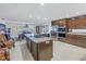 Modern kitchen boasts stainless steel appliances, kitchen island with cooktop, and open dining area at 1990 59Th N St, St Petersburg, FL 33710