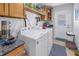 Efficient laundry area features modern white washer and dryer, storage, and convenient access to the exterior at 1990 59Th N St, St Petersburg, FL 33710