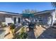 Cozy patio area with dining table, umbrella, and lush potted plants, perfect for outdoor entertaining at 1990 59Th N St, St Petersburg, FL 33710