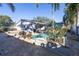 Beautiful backyard featuring a swimming pool, patio, hot tub, palm trees, and lush landscaping at 1990 59Th N St, St Petersburg, FL 33710
