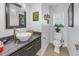Tastefully updated powder room featuring stylish vessel sink, granite countertop, modern faucet, and designer mirror at 1990 59Th N St, St Petersburg, FL 33710