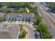 An aerial view showcases the charming townhomes with a lovely landscape, situated conveniently near a road at 2013 Sunset Wind Loop, Oldsmar, FL 34677