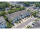 Charming townhomes feature attached garages, light blue accents, and convenient parking in a desirable community at 2013 Sunset Wind Loop, Oldsmar, FL 34677