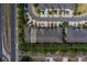 Overhead view of townhome complex with ample parking, surrounding greenery, and nearby roadways at 2013 Sunset Wind Loop, Oldsmar, FL 34677