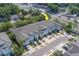 Charming townhomes feature attached garages, light blue accents, and convenient parking in a desirable community at 2013 Sunset Wind Loop, Oldsmar, FL 34677