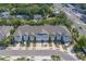 Charming townhomes feature attached garages, light blue accents, and convenient parking in a desirable community at 2013 Sunset Wind Loop, Oldsmar, FL 34677