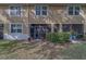 Enclosed back patio of townhome showing screened in lanai with patio and landscaping at 2013 Sunset Wind Loop, Oldsmar, FL 34677