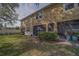 A backyard is shown with an enclosed patio and screened in lanai, and established landscaping at 2013 Sunset Wind Loop, Oldsmar, FL 34677
