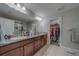 Bathroom with double sinks, granite countertop, and walk-in closet offers space and convenience at 2013 Sunset Wind Loop, Oldsmar, FL 34677