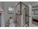 An ensuite bathroom featuring a glass-enclosed shower, toilet, and ample counter space at 2013 Sunset Wind Loop, Oldsmar, FL 34677