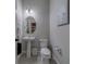 Bright half bathroom with a pedestal sink, tile flooring, and decorative art creating a cozy atmosphere at 2013 Sunset Wind Loop, Oldsmar, FL 34677