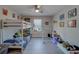 bedroom featuring gray laminate flooring, a ceiling fan, bunk beds, and wall art at 2013 Sunset Wind Loop, Oldsmar, FL 34677