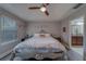 Bright bedroom with lots of natural light, tray ceiling, and ensuite bathroom at 2013 Sunset Wind Loop, Oldsmar, FL 34677