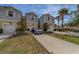 Attractive townhome with two-car garage, tidy front lawn, and a modern vehicle parked in the driveway at 2013 Sunset Wind Loop, Oldsmar, FL 34677