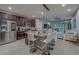 Open kitchen showcasing granite island with seating, dark cabinets, stainless steel appliances, and adjacent living area at 2013 Sunset Wind Loop, Oldsmar, FL 34677