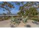 Outdoor seating area with a fire pit provides a relaxing space by the water at 2013 Sunset Wind Loop, Oldsmar, FL 34677