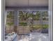 Serene screened patio with outdoor furniture, decorative elements, and views of the private backyard at 2013 Sunset Wind Loop, Oldsmar, FL 34677