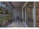Enclosed patio featuring tiled flooring, a peek of the backyard, and easy access to the interior at 2013 Sunset Wind Loop, Oldsmar, FL 34677