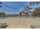 A serene community pool overlooks a calm body of water in a beautiful setting at 2013 Sunset Wind Loop, Oldsmar, FL 34677
