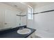 Bathroom with a white vanity, large mirror, and a shower-tub combo with white tiles at 20221 Vintage Oaks Pl, Tampa, FL 33647