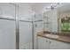 Bathroom featuring a glass-enclosed shower, vanity with sink, and large mirror at 20221 Vintage Oaks Pl, Tampa, FL 33647