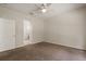 Bedroom boasts neutral carpet, ceiling fan, and archway leading to en-suite bathroom at 20221 Vintage Oaks Pl, Tampa, FL 33647