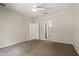 Bedroom with neutral carpet, ceiling fan, arched entryway, and access to a walk-in closet at 20221 Vintage Oaks Pl, Tampa, FL 33647
