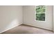 Neutral bedroom with neutral carpet features a large window providing natural light at 20221 Vintage Oaks Pl, Tampa, FL 33647